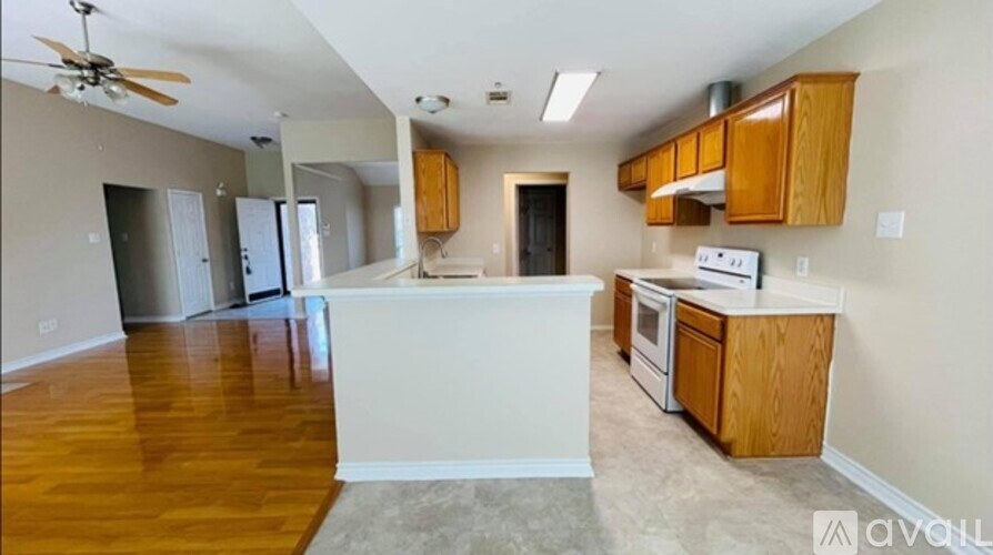 A kitchen with wooden cabinets and a white island.