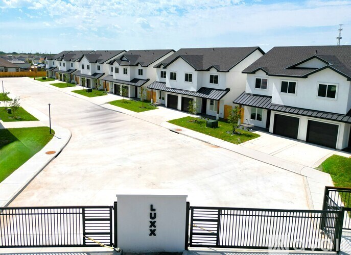 A row of houses with a sign that says "LUXE" in front of them.