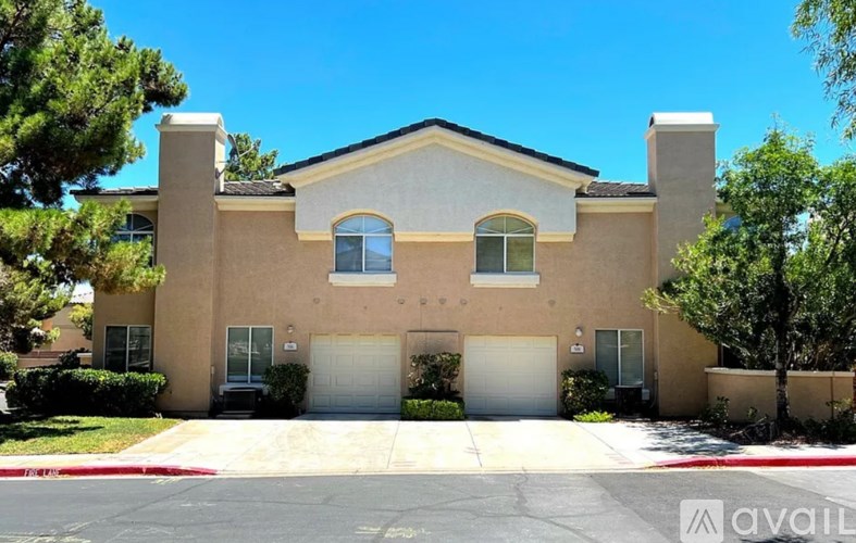 A two-story house with a garage on the ground floor.