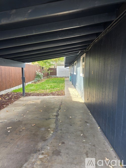 A long concrete pathway leads to a building.