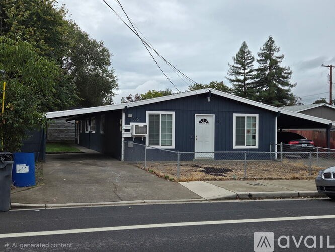 A blue house with a white door and windows.