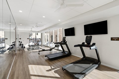 A gym with treadmills and exercise bikes.