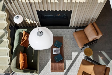 A living room with a couch, a table, and a lamp.