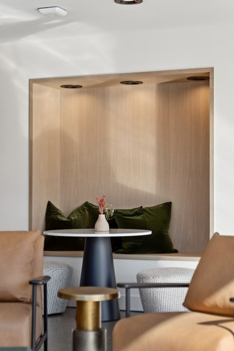 A modern dining area with a round table and chairs.