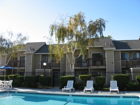 A swimming pool in front of apartment buildings.