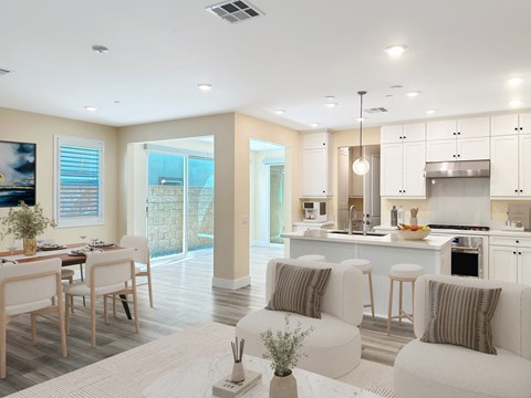 A modern kitchen with a dining table and chairs.
