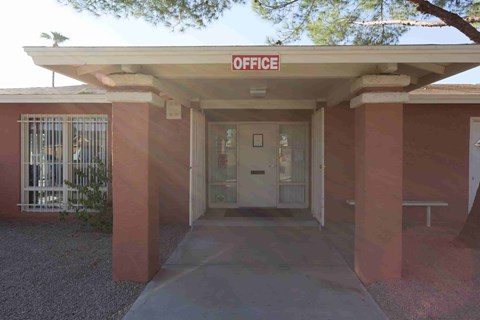 A building with a red sign that says "OFFICE" on top.