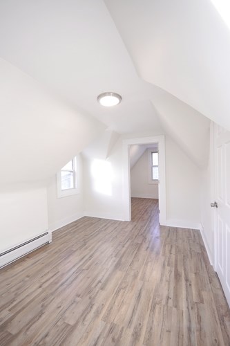 A room with wooden floors and white walls.