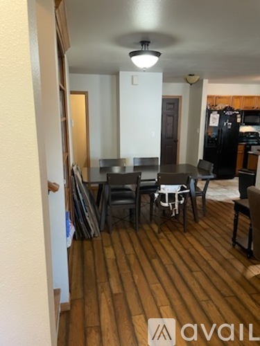 A dining room with a table and chairs.