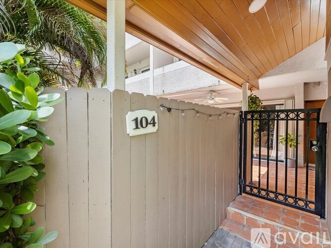 A wooden fence with the number 104 on it.