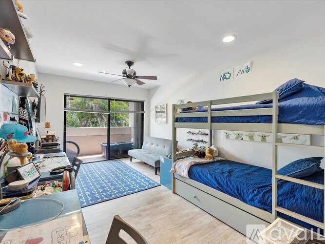 A bedroom with a bunk bed and a desk with a chair.