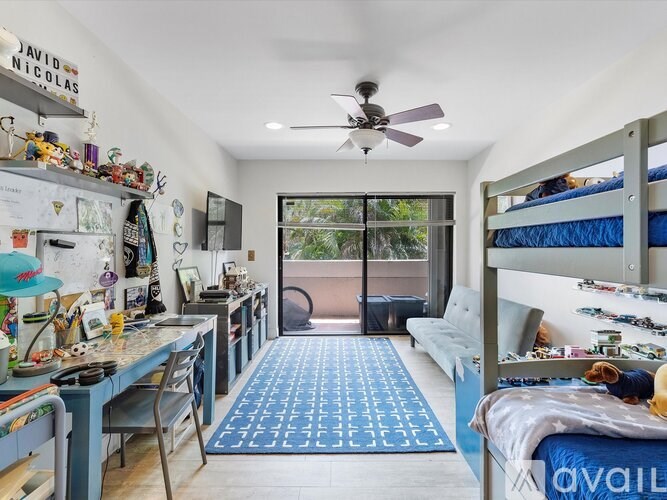 A room with a blue carpet and a bunk bed.