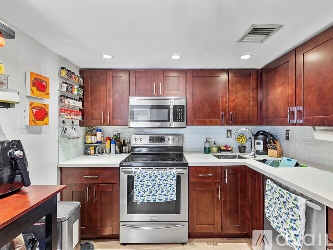 A kitchen with a stove top oven and a microwave.