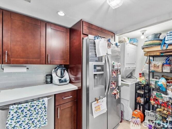 A kitchen with brown cabinets and a white countertop.