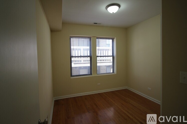 A room with a window and wooden floors.