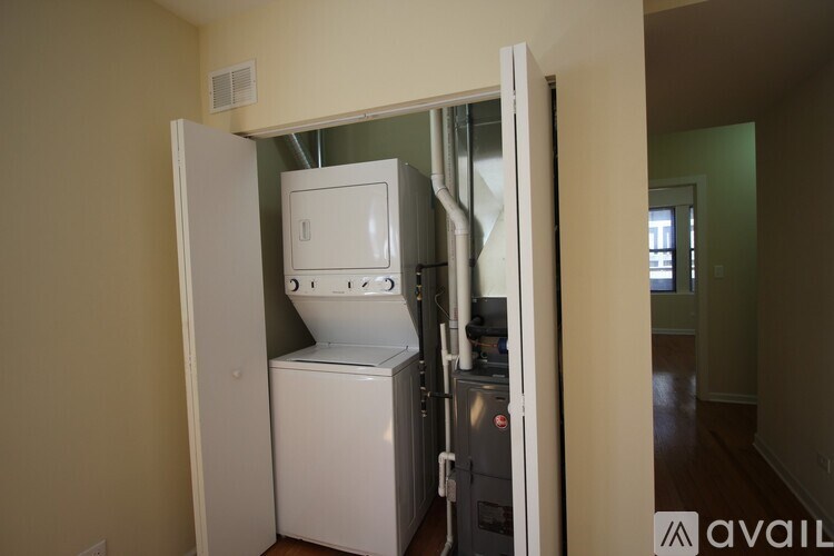 A white washing machine is in a doorway.