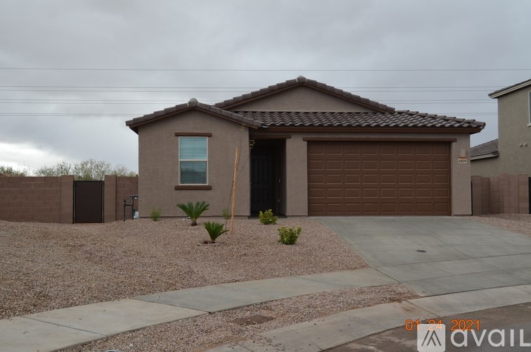 A house with a brown garage door and a driveway in front.