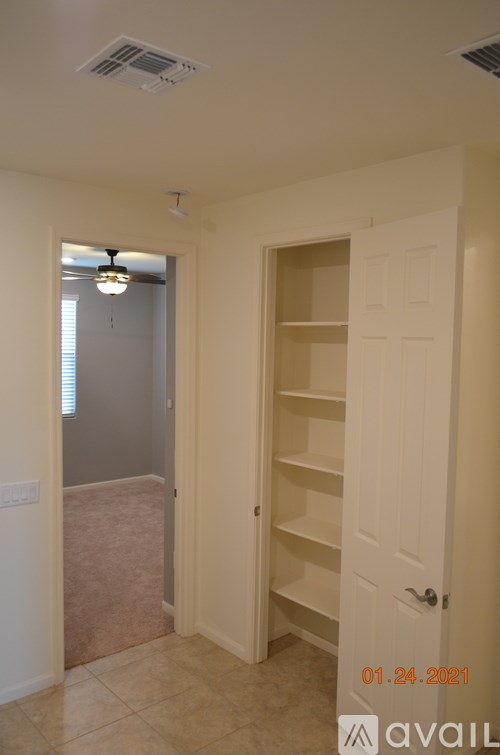 A room with a white door and a light on the ceiling.