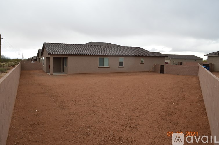 A house with a brown roof and a brown fence is available for rent.