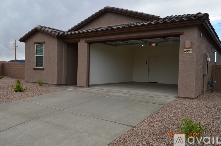 A house with a garage and a driveway in front.