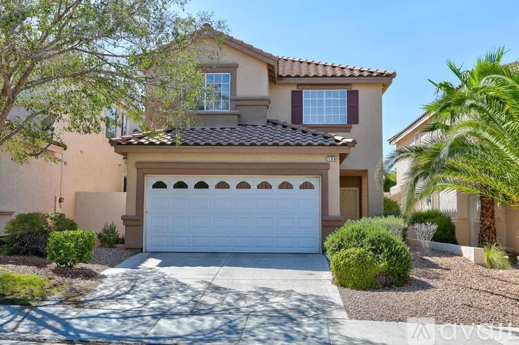 A house with a white garage door and a brown roof.