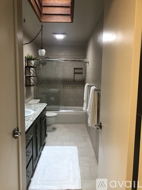 A bathroom with a walk in shower and a toilet.