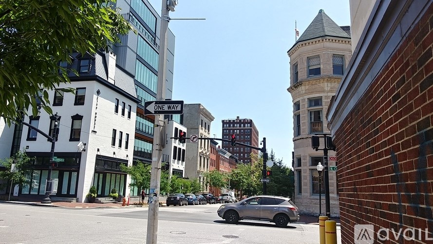 A street view with a car parked on the side of the road.