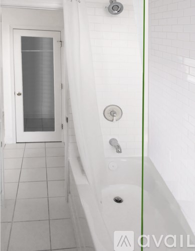 A wall-mounted thermostat and control panel are displayed on a white wall.