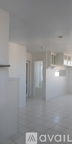 A white cabinet with a black top is in the foreground of the image.