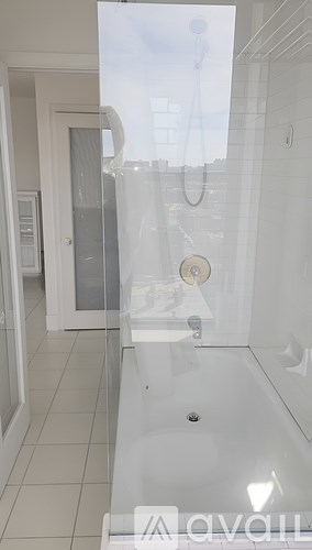 A hallway with a patterned carpet and a mirror on the wall.