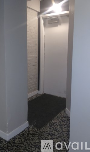 A hallway with a black and white patterned floor.