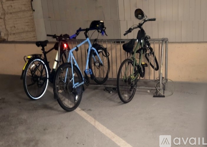 Three bikes are parked next to each other in a dimly lit area.