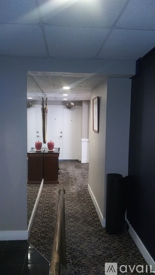 A hallway with a black and white checkered floor.