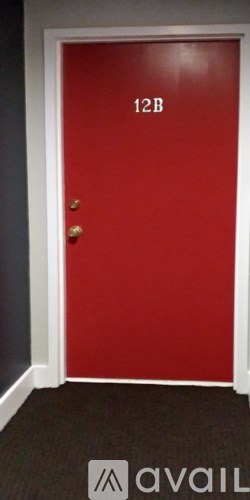 A red door with the number 12B on it.