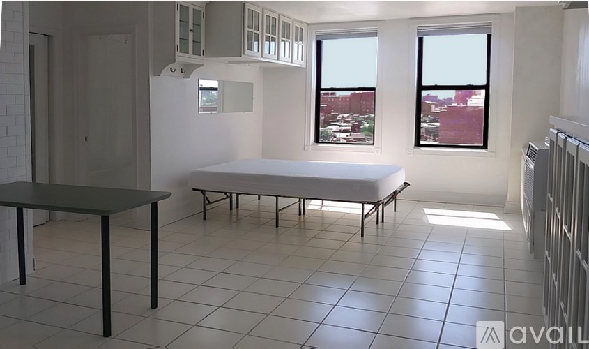 A room with a table and a bed in it.