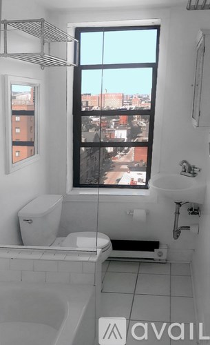 A building with a balcony and a black railing.