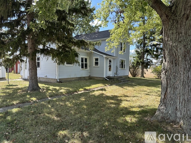 A house with a tree in front of it.