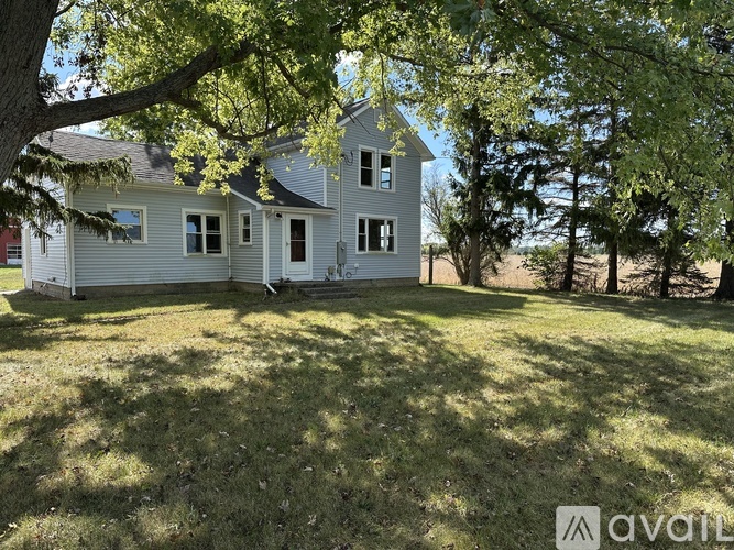 A house with a tree in front of it is for sale.