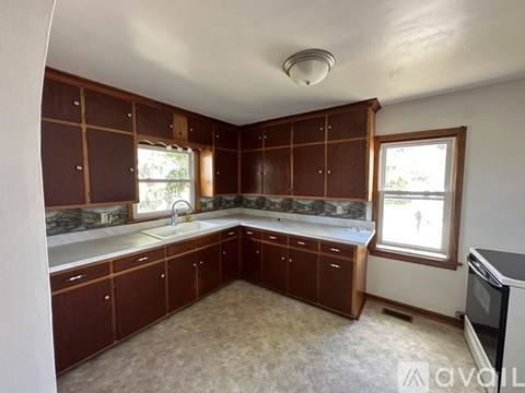 A kitchen with brown cabinets and a white countertop.