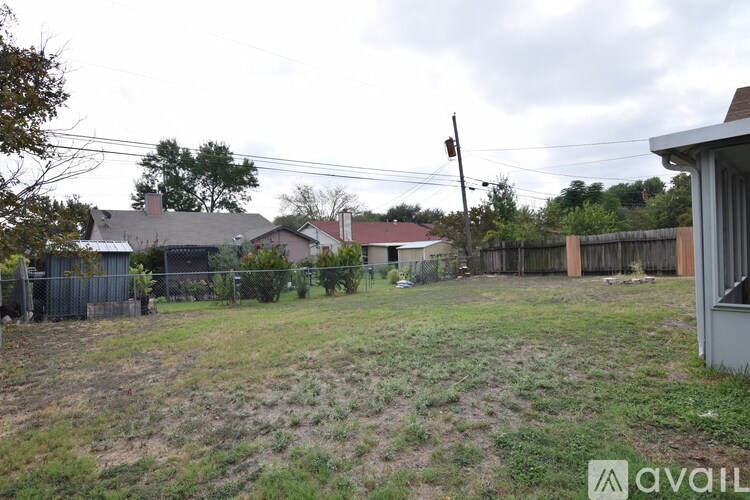 A living room with a fireplace and a ceiling fan.