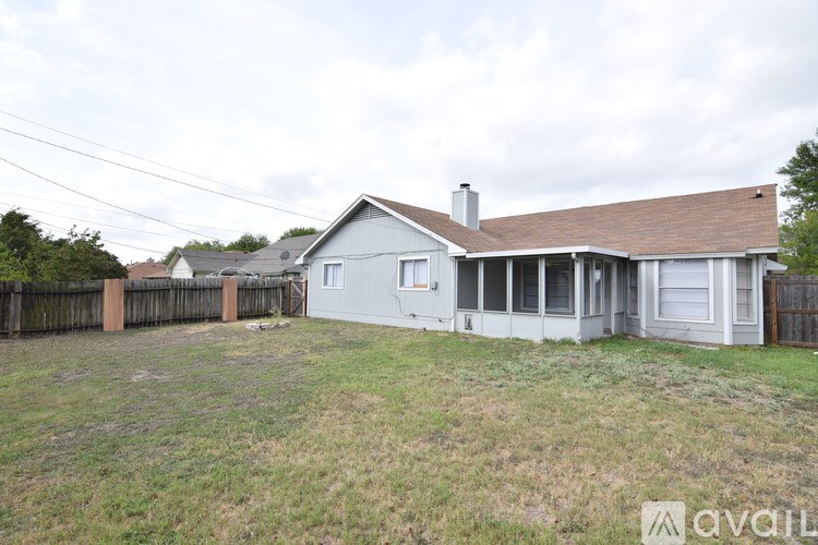A house with a fence and a grassy yard is for sale.
