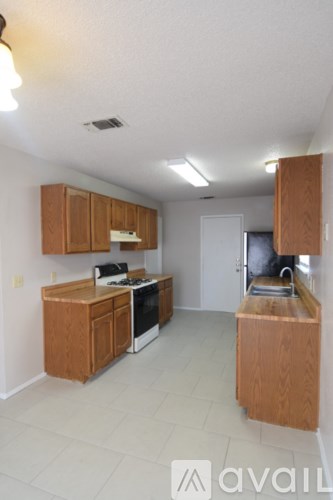 A kitchen with wooden cabinets and a white oven.