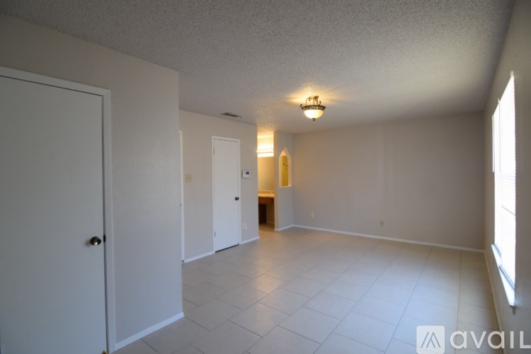 A room with white walls and a white tile floor.