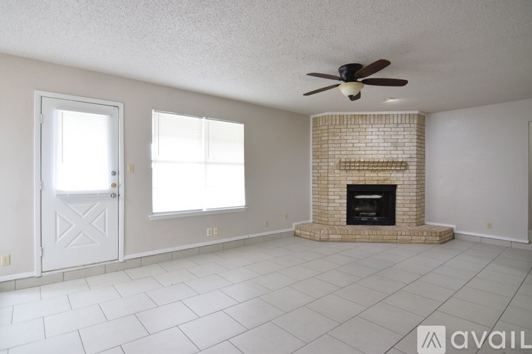 A kitchen with wooden cabinets and a black refrigerator.