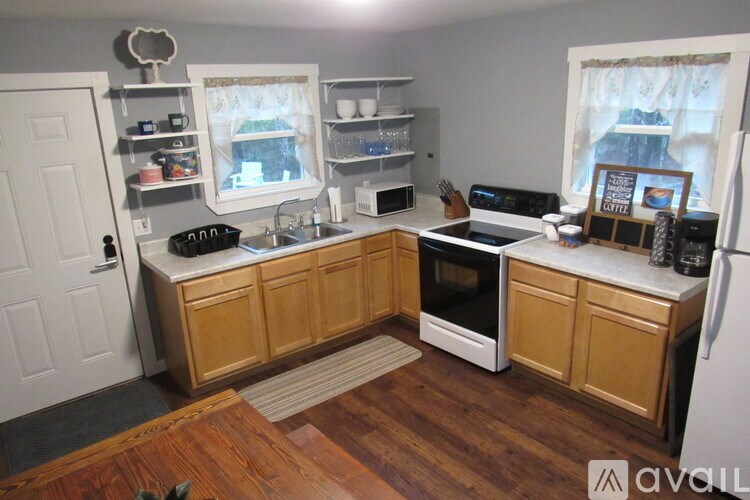 A kitchen with wooden cabinets and a white refrigerator.