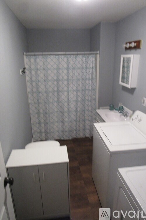 A small laundry room with a washer and dryer.