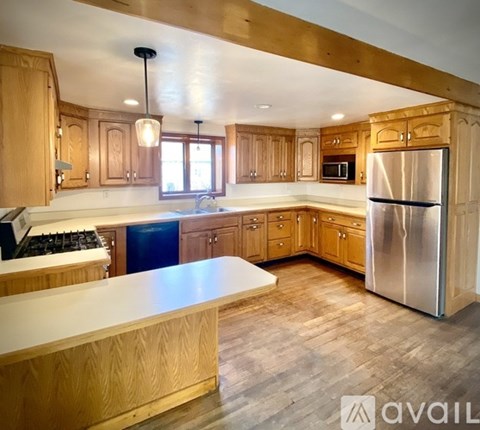 A kitchen with wooden cabinets and a white countertop.