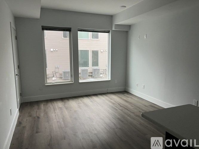 A bathroom with a white door and a white toilet.