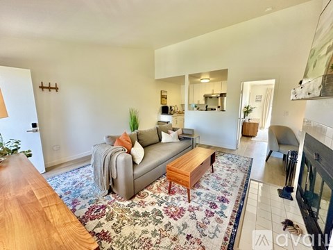 A living room with a grey couch and a wooden coffee table.