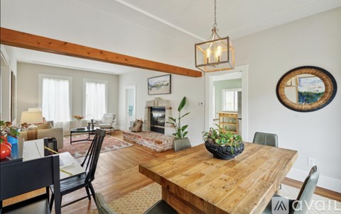 A dining room with a wooden table and chairs.